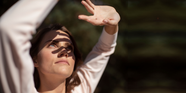 Woman looking up to the sun